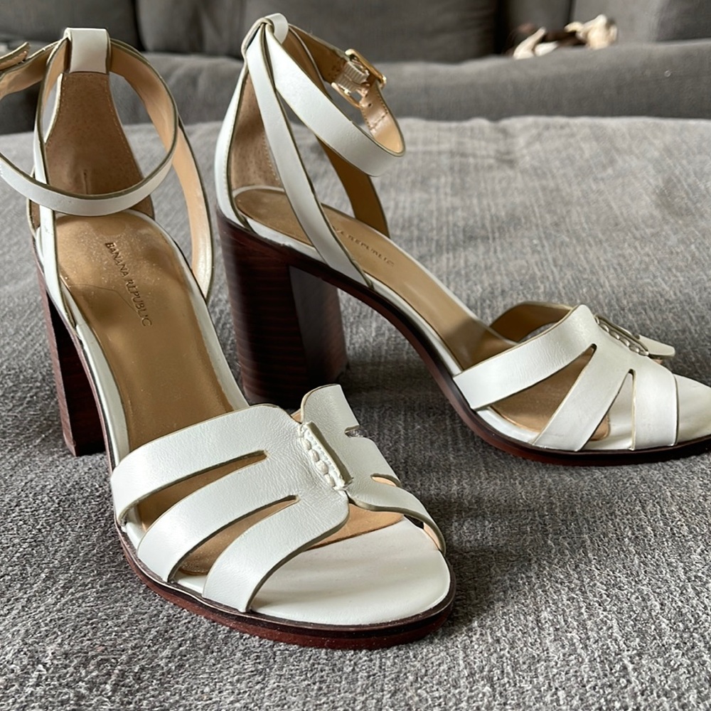 Sleek white leather sandals with a wood heel.